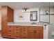 Bathroom showcasing wood cabinets, granite countertops, and a glass-enclosed shower with stylish tile accents at 17408 Gulf Blvd # 203, Redington Shores, FL 33708