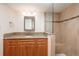 Bathroom with granite counters, vanity and custom tiled walk-in shower with glass door at 17408 Gulf Blvd # 203, Redington Shores, FL 33708