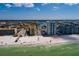 Aerial view of beachfront condos with white sands and turquoise ocean waters under a bright blue sky at 17408 Gulf Blvd # 203, Redington Shores, FL 33708