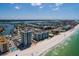 Aerial shot of beachfront condos with clear ocean views, providing an idyllic coastal living experience at 17408 Gulf Blvd # 203, Redington Shores, FL 33708