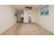 Neutral bedroom featuring a ceiling fan, carpeted floor, and a view into the bathroom and walk-in closet at 17408 Gulf Blvd # 203, Redington Shores, FL 33708