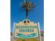 Sign welcoming visitors to Redington Shores, adorned with a palm tree against a clear blue sky at 17408 Gulf Blvd # 203, Redington Shores, FL 33708