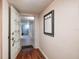 Hallway view with tiled floors transitioning to wood, and an open entryway ahead at 17408 Gulf Blvd # 203, Redington Shores, FL 33708