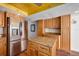 Spacious kitchen with wooden cabinets, stainless steel appliances, and a center island at 17408 Gulf Blvd # 203, Redington Shores, FL 33708