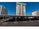 Parking with building view featuring covered parking spaces with building in the background at 17408 Gulf Blvd # 203, Redington Shores, FL 33708