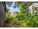 A beautiful backyard with lush greenery and mature trees, creating a serene and private outdoor space at 1815 Cypress Trace Dr, Safety Harbor, FL 34695