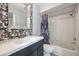 Bathroom featuring modern vanity, decorative tiles, a shower-tub combo, and updated fixtures at 1815 Cypress Trace Dr, Safety Harbor, FL 34695
