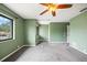 A spacious bedroom featuring carpeting, neutral paint, ceiling fan and natural light from a window at 1815 Cypress Trace Dr, Safety Harbor, FL 34695