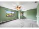 A spacious bedroom featuring carpeting, neutral paint, ceiling fan and natural light from a window at 1815 Cypress Trace Dr, Safety Harbor, FL 34695