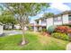 Charming townhome with well-manicured lawn, landscaping, and neutral exterior paint with a brown trim at 1815 Cypress Trace Dr, Safety Harbor, FL 34695