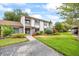 Charming two-story home with landscaped yard and inviting front entrance at 1815 Cypress Trace Dr, Safety Harbor, FL 34695
