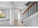 Bright foyer featuring tiled flooring, staircase, and access to a spacious living area at 1815 Cypress Trace Dr, Safety Harbor, FL 34695
