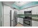 Modern kitchen featuring stainless steel appliances, tile backsplash and sleek countertops at 1815 Cypress Trace Dr, Safety Harbor, FL 34695