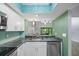 Well-lit kitchen with updated appliances, granite counters, stylish backsplash, and an opening to the dining area at 1815 Cypress Trace Dr, Safety Harbor, FL 34695