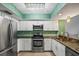 Modern kitchen with stainless steel appliances, granite countertops, and ample cabinetry at 1815 Cypress Trace Dr, Safety Harbor, FL 34695
