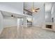 Open living space with high ceilings, tile floors, fireplace, and bar seating at 1815 Cypress Trace Dr, Safety Harbor, FL 34695