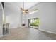 Well-lit living area featuring tall ceilings, clerestory windows, fireplace, and patio access at 1815 Cypress Trace Dr, Safety Harbor, FL 34695