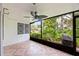 An enclosed patio featuring a ceiling fan and a decorative tiled floor at 1815 Cypress Trace Dr, Safety Harbor, FL 34695