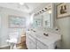 Bright bathroom featuring dual sinks, a mirrored cabinet, and a classic toilet for everyday convenience at 18675 Us Highway 19 N # 261, Clearwater, FL 33764
