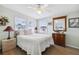 Cozy bedroom with wood floors, a large window, and quaint furniture providing a comfortable retreat at 18675 Us Highway 19 N # 261, Clearwater, FL 33764