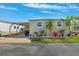 Charming home with covered parking and nicely landscaped front flower bed with mature trees at 18675 Us Highway 19 N # 261, Clearwater, FL 33764