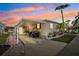 Beautiful home at dusk featuring covered parking and colorful flower garden at 18675 Us Highway 19 N # 261, Clearwater, FL 33764