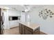Kitchen with an island, wood flooring, and white cabinets, open to the front door at 18675 Us Highway 19 N # 261, Clearwater, FL 33764