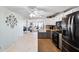 Open kitchen featuring white cabinets, stainless steel appliances, and a view into the living area at 18675 Us Highway 19 N # 261, Clearwater, FL 33764