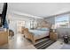 Bright main bedroom with wood floors, a ceiling fan, and large windows with ample natural light at 18675 Us Highway 19 N # 261, Clearwater, FL 33764