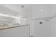 Modern bathroom featuring a glass enclosed shower, white tile, a gray accent, and a marble countertop at 19212 Sunlake Blvd, Lutz, FL 33558