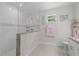 Bright bathroom featuring a glass-enclosed shower, a window, and decorative accents for a spa-like feel at 19212 Sunlake Blvd, Lutz, FL 33558
