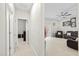 Hallway leading to a bright living room with modern decor and comfortable seating at 19212 Sunlake Blvd, Lutz, FL 33558