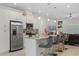 Modern kitchen featuring stainless steel appliances, a breakfast bar, and stylish pendant lighting at 19212 Sunlake Blvd, Lutz, FL 33558