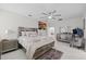 Elegant main bedroom with neutral walls, a statement bed, modern furniture, and a decorative rug at 19212 Sunlake Blvd, Lutz, FL 33558