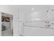 Modern shower featuring white tile, a gray tile accent, and a glass partition, for a clean, bright look at 19212 Sunlake Blvd, Lutz, FL 33558