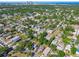 Aerial image of a neighborhood with a mix of houses surrounded by lush greenery and the city skyline in the background at 2018 21St S St, St Petersburg, FL 33712