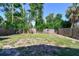A spacious backyard is enclosed by a wooden fence and lush greenery at 2018 21St S St, St Petersburg, FL 33712