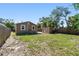 Backyard with a shed, well-maintained lawn, and lush greenery at 2018 21St S St, St Petersburg, FL 33712