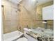 Bathroom featuring tan tile, granite countertops, and glass vessel sink at 2018 21St S St, St Petersburg, FL 33712