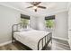 Bedroom features hard surface floors, two windows, and a black iron bed frame at 2018 21St S St, St Petersburg, FL 33712