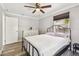 This cozy bedroom features wood-look floors, a ceiling fan, and a bright window at 2018 21St S St, St Petersburg, FL 33712