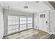 Welcoming foyer with tiled floor, three large windows and paneled front door at 2018 21St S St, St Petersburg, FL 33712
