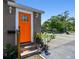 Welcoming home entrance with a vibrant door, manicured plants, and ambient lighting at 2018 21St S St, St Petersburg, FL 33712