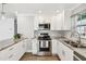 Bright kitchen with granite counters, stainless appliances, and white subway tile backsplash at 2018 21St S St, St Petersburg, FL 33712