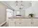 Bright kitchen island features granite countertops and shaker style cabinets, open to living area at 2018 21St S St, St Petersburg, FL 33712