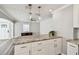 Bright kitchen island features granite countertops and shaker style cabinets, open to living area at 2018 21St S St, St Petersburg, FL 33712