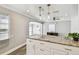 Bright kitchen island features granite countertops and shaker style cabinets, open to living area at 2018 21St S St, St Petersburg, FL 33712