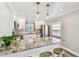 Bright kitchen features stainless appliances, granite countertops, and pendant lighting over breakfast bar at 2018 21St S St, St Petersburg, FL 33712