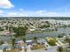 Breathtaking aerial view of a waterfront community with numerous homes and lush greenery on a sunny day at 2252 Society Dr, Holiday, FL 34691