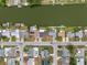 A top-down aerial view shows a waterfront neighborhood with evenly spaced homes and canals along the street at 2252 Society Dr, Holiday, FL 34691